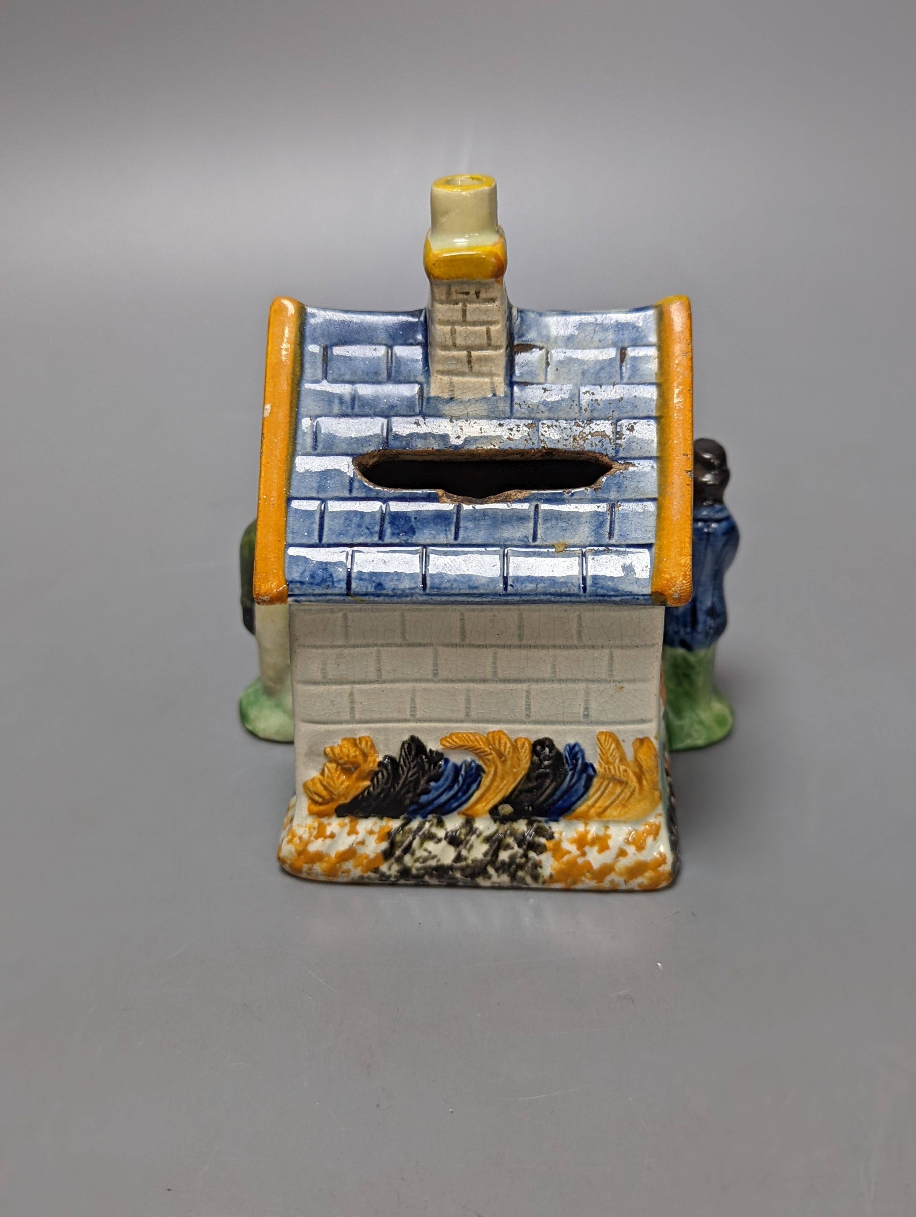 A Staffordshire Prattware money box, c.1810, and another later example (2) both 12.5cm, faults